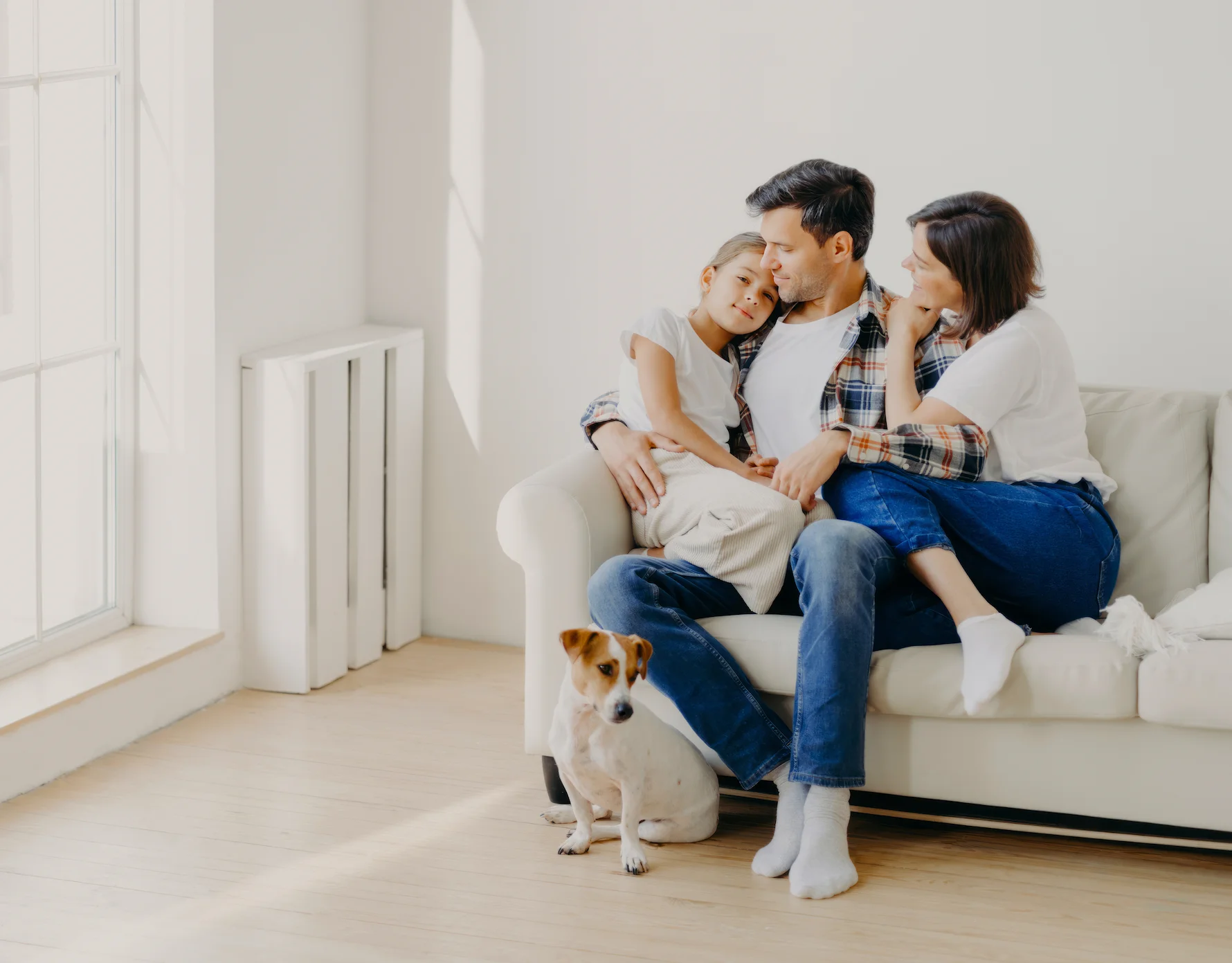 Family relaxing together at home in a bright living space near the Live at Finestra townhomes in South Surrey