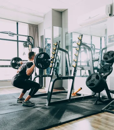 Person working out in a modern fitness gym near the Live at Finestra townhome community in South Surrey